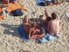 Group of guys having sex on the beach