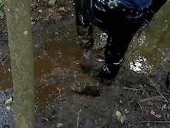 Vinyl mini skirt, thigh high boots in deep mud!